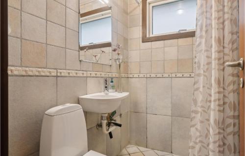 a bathroom with a toilet and a sink at Granly in Hasle