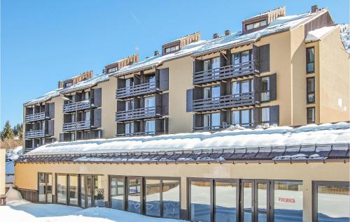 a building with snow on top of it at Cozy Apartment In Vason With Kitchen in Vason