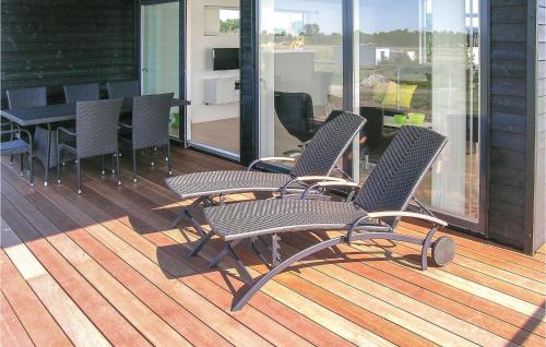 two chairs and a table on a deck at Holiday Home Frederikshavn 41 in Frederikshavn