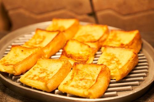 a pile of toast on a metal plate at Hotel Global View Hakodate in Hakodate