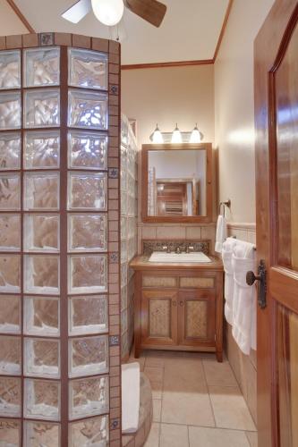 a bathroom with a sink and a mirror at Coco Beach Resort in San Pedro