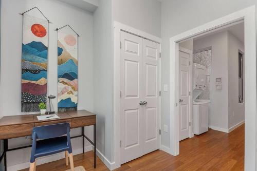 a home office with a desk and a painting on the wall at Prime OTR off Vine St, Lux Full Bed, Fast WiFi, Fully Equipped, 50in TV, Sleeps 4ppl in Cincinnati