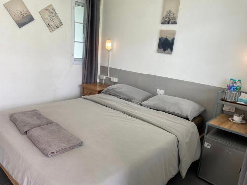 Una cama o camas en una habitación de Phutawan Pundao