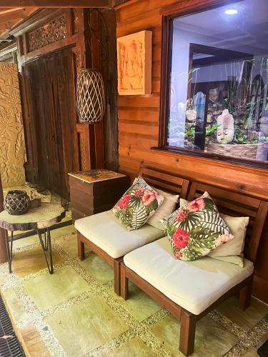 a room with a bench and a window and a table at Whitsundays BNB Retreat in Airlie Beach