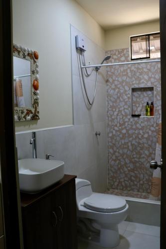 a bathroom with a toilet and a sink and a shower at La Vidita 891 - Piscinas, Lobitos in Lobitos