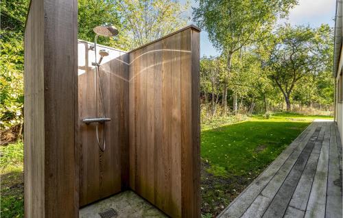 a wooden shower door with a wooden walkway at Beautiful Home In Sjællands Odde With 5 Bedrooms in Yderby
