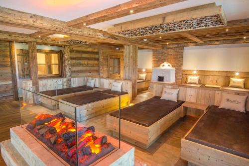a large room with a fireplace and wooden walls at Natur-Wohlfühlhotel Brunner Hof in Arnschwang