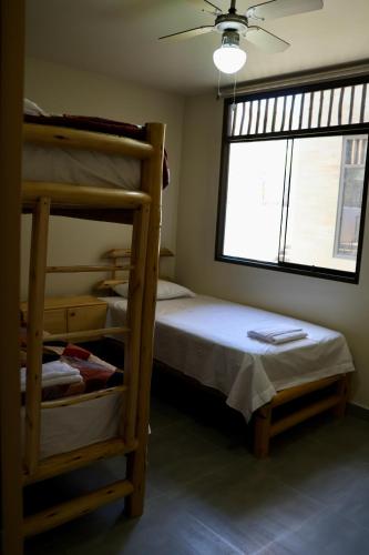 a bedroom with two bunk beds and a window at La Vidita 891 - Piscinas, Lobitos in Lobitos