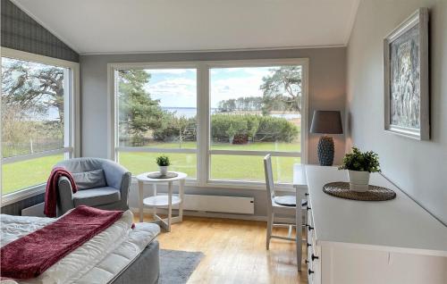 a kitchen and living room with a large window at Amazing Home In Rockneby With Wifi in Rockneby