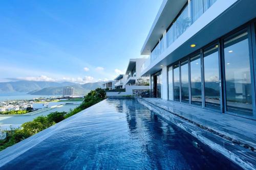 a swimming pool on the side of a building at Anh Nguyen Oceanfront Luxury Villas Nha Trang in Nha Trang