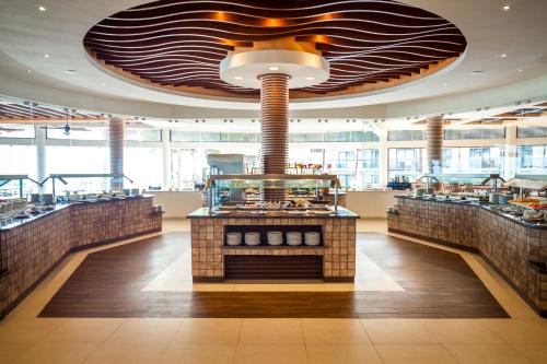 a large restaurant with a large ceiling at The Reef Coco Beach Resort & Spa- Optional All Inclusive in Playa del Carmen