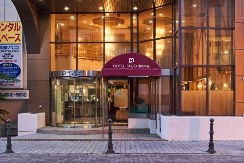 a building with a purple awning in front of it at Hotel Paco Obihiro Chuo in Obihiro