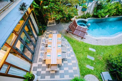 an overhead view of a table with chairs next to a pool at Laluka House in Hoi An