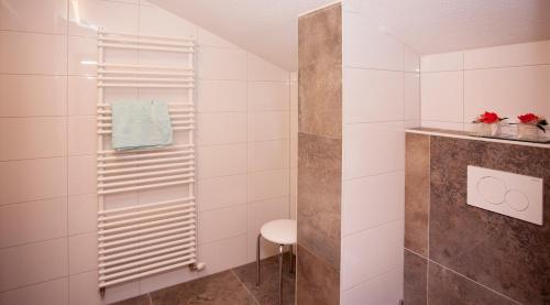 a bathroom with a shower and a stool at Haus Tyrol in See