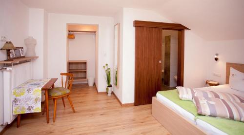 a bedroom with a bed and a desk and a table at Haus Tyrol in See