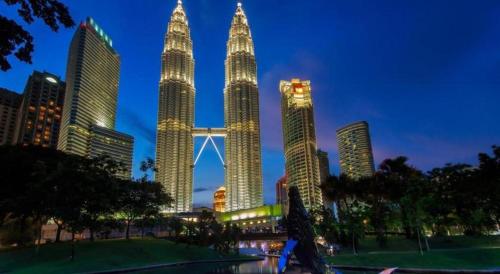 a group of tall skyscrapers in a city at night at My Home Hotel Wangsa Maju in Kuala Lumpur