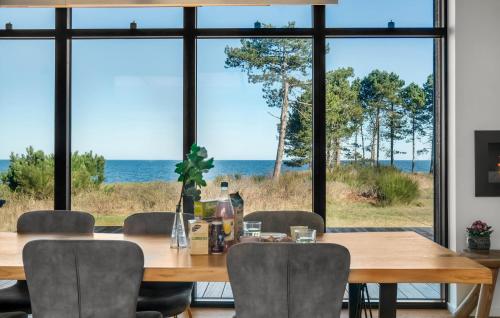 a dining room with a table with chairs and a view of the ocean at Stunning Home In Kalundborg With Wifi in Kalundborg