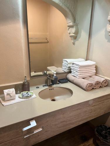 a bathroom with a sink and a mirror and towels at “Magic Sunrise at Cancun” in Cancún