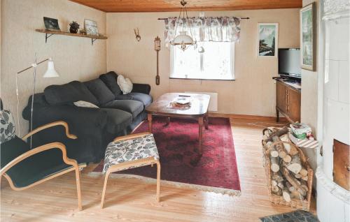 a living room with a couch and a table at One-Bedroom Holiday Home In Unnaryd in Unnaryd