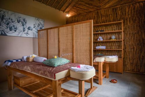 a bedroom with a bed and a book shelf at The Mesare Eco Resort in Nusa Penida