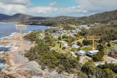 an aerial view of a beach with two street signs at Suntrap Cove - you and the ocean in Bicheno