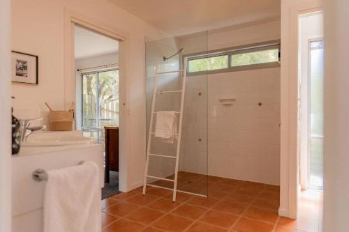 a bathroom with a shower and a sink at Suntrap Cove - you and the ocean in Bicheno