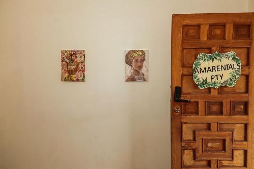 three pictures on a wall next to a door at Apartamento en el Corazón de Boquete in Boquete