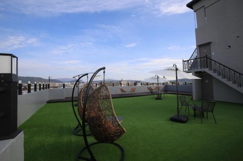a balcony with green grass and a slide at Hotel rein in Gyeongju