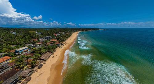 an aerial view of the ocean and a beach at Sea Shine Guest House in Hikkaduwa