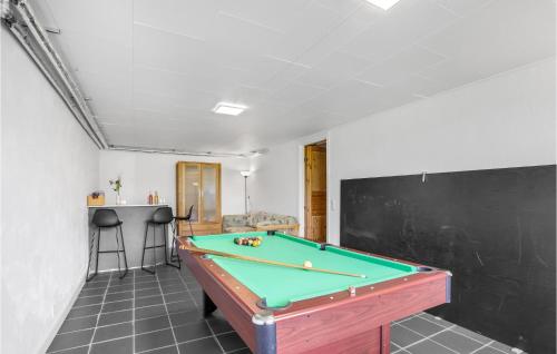 a pool table in a room with a black wall at 5 Bedroom Lovely Home In Allinge in Allinge