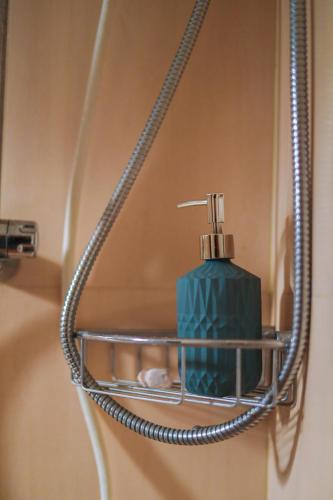 a soap dispenser hanging on a bathroom wall at Urban Garden Vacation Rental in Kandy