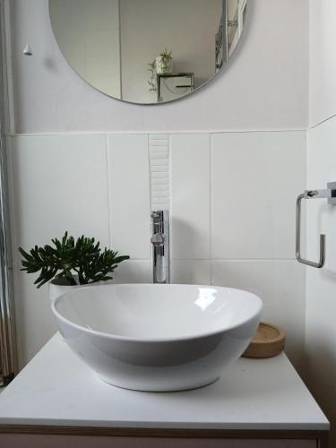 a bathroom with a white sink and a mirror at Seaview in Stornoway