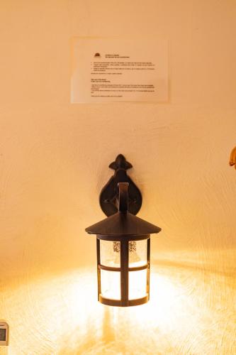 a light that is sitting on a wall at Casa de hospedaje -La Abadía de San Pedro in Guadalajara