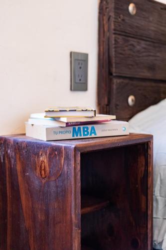 two books sitting on top of a wooden table at Casa de hospedaje -La Abadía de San Pedro in Guadalajara