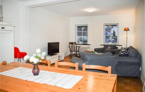 a living room with a couch and a table at 4 Bedroom Pet Friendly Home In Äsperöd in Äsperöd