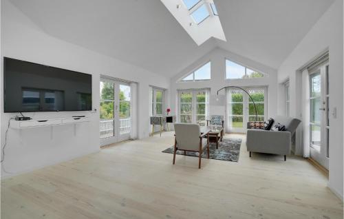 a living room with white walls and a large tv at Lovely Home In Rødvig Stevns With Wifi in Rødvig