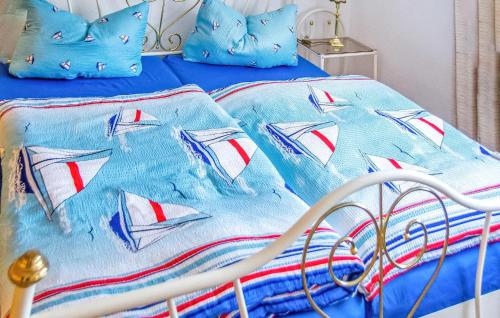 a bed with a blue comforter and pillows on it at Ferienwohnung Friedrichroda in Friedrichroda