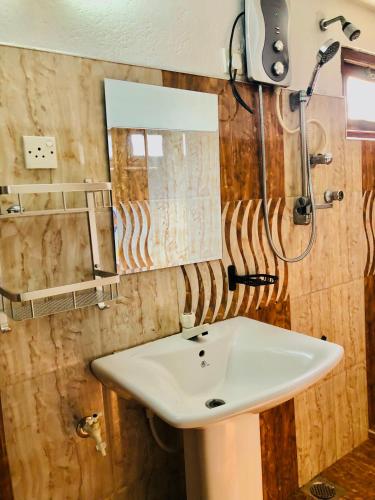 a bathroom with a sink and a mirror at Weligama Bay House in Weligama