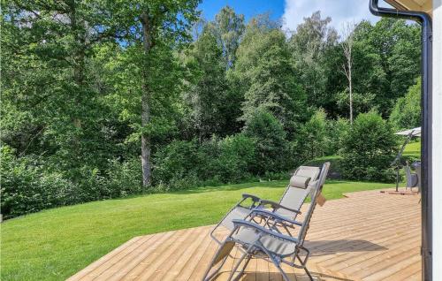 a blue chair sitting on a wooden deck at Stunning Home In Tvärred With Kitchen in Alhammar