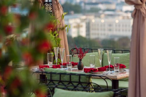a table with glasses and red napkins on a balcony at Hanoi Tirant Hotel in Hanoi
