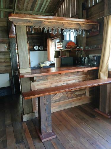 a wooden bench sitting inside of a room at Hiva oa chalets in Atuona