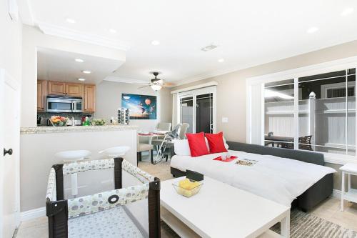 a living room with a couch and a dining room at Costa Mesa -Newport- Patio - Free Parking-CM-2 in Costa Mesa