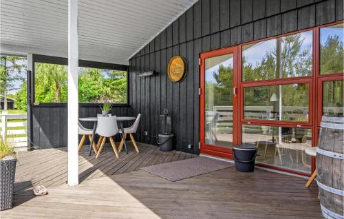 a patio with a table and a clock on the wall at Beautiful Home In Skjern With Kitchen in Skjern