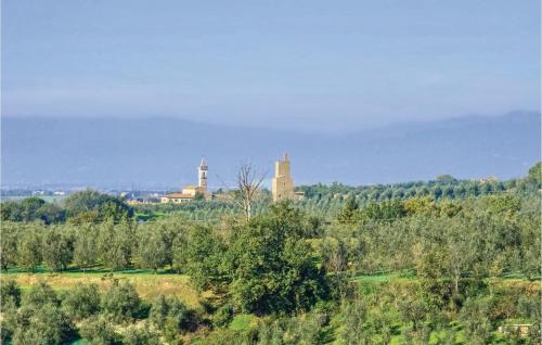 a field with trees and a castle in the distance at Poggioalvento in Lazzeretto