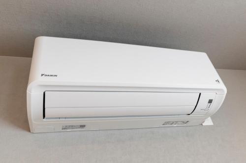 a white printer sitting on top of a table at The Comfy Sapporo in Ōdōri