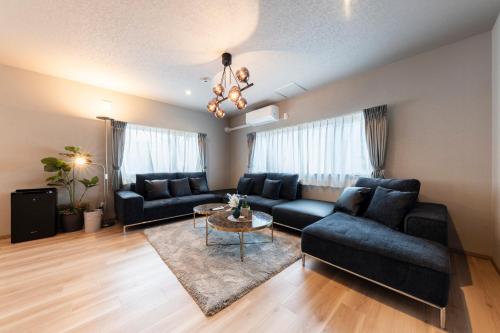 a living room with a couch and a table at The Comfy Sapporo in Ōdōri