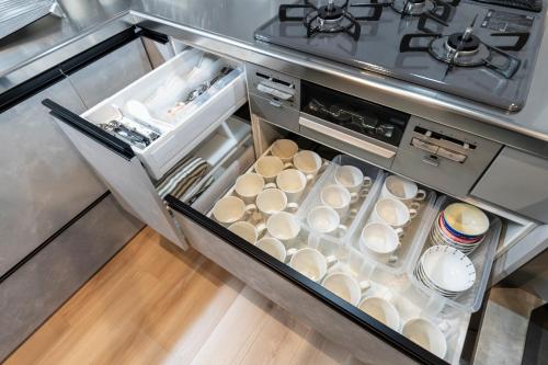 an open refrigerator filled with lots of dishes at The Comfy Sapporo in Ōdōri