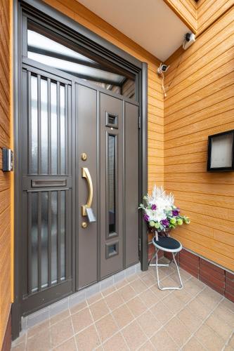 a front door of a house with a vase of flowers at The Comfy Sapporo in Ōdōri