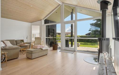 a living room with a couch and a table at Stunning Home In Børkop in Børkop