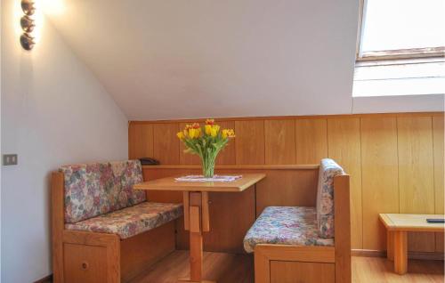 a room with a table and two chairs and a vase of flowers at 1 Bedroom Gorgeous Apartment In Vason in Vason